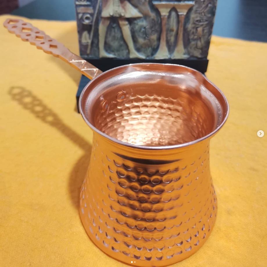 cafetera sin tapa, de acero inoxidable color cobre y relieves de puntos.